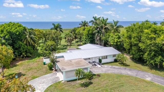 A home under the palms on the Lake Okeechobee shore in Pahokee, the lake behind it